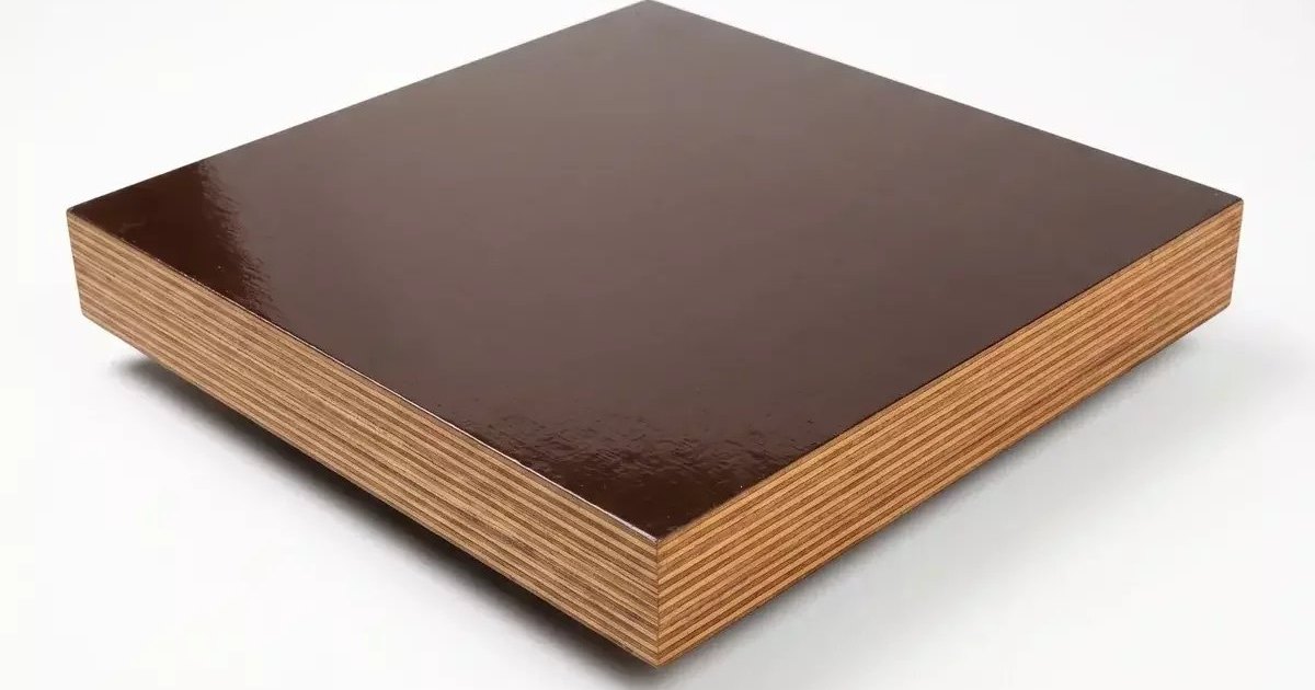 A thick brown-faced plywood panel with its layered edge visible against a plain background